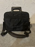 Front view of Dell black nylon laptop briefcase with shoulder strap attached