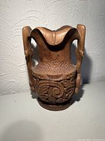 front view showing carved relief and handles