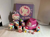 Group shot showing plush toy, hat, canvas art and all mini figures