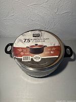 Sealed Dutch oven with retail label showing brand, size and image