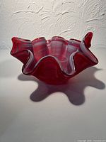 Angled view showing ruffled rim and red-white striped glass
