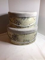 Two floral fabric hat boxes stacked