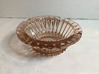 Top view showing ribbed sides and scalloped rim of pink glass ashtray