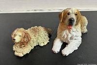 Both dog figurines side by side