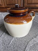 Front view of jar showing lid, handle and two-tone glaze