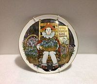 Front view of plate showing full design and gold rim