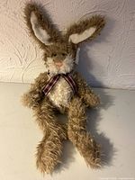 Full view of seated tan and white bunny plush showing overall appearance