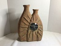 Front view showing double neck and sun motif