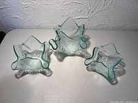 Three small ruffled glass bowls overhead view