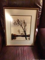 Full view of framed landscape print on chair