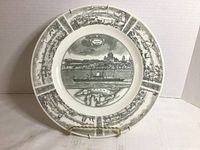 Front view of commemorative plate on stand, showing full design and surface condition