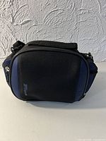 Front view of Targus camera bag showing black and blue panels and zipper closure