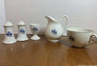 Front view of all five porcelain pieces aligned