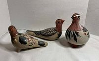 Front view of all three bird figurines
