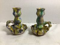 Front view of both glazed ceramic candlesticks