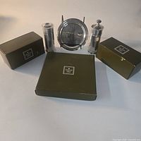 Group shot of two shakers, tray in stand, and original Christofle boxes