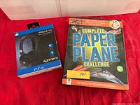 Headset box and paper plane kit side by side