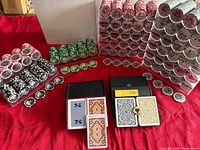 Overall view of chips in racks, green and black chip stacks, four card decks in two cases