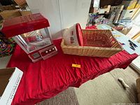 Overview of crane game, wicker basket with bowl and wire basket