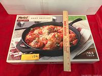Front of unopened box showing Parini cast iron deep skillet