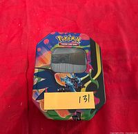 Closed Pokémon tin showing Charizard art and lot number