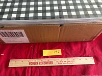 Closed box with shipping label and ruler indicating scale