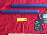 Two purple cylindrical Starbucks travel cases with hang tags visible.