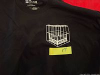 Front view showing Hell In A Cell cage graphic and size tag