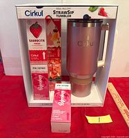 Front view of boxed Cirkul StrawSip Tumbler set showing tumbler and four flavor cartridges