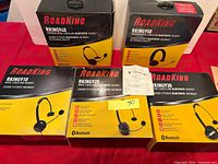 Five boxed RoadKing headsets on table