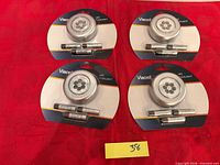 Front view showing four sealed Viacell LED puck lights with batteries