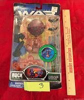 Front view of sealed War Planets Rock Moon playset showing all components in blister pack with ruler for scale