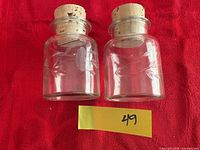 Two etched glass spice jars with corks