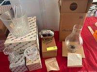 Group shot showing ice bucket on box, metal canister, hurricane shade, additional boxes and leaflets