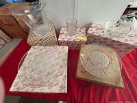 Overall lot showing vase, dinner plates, tray, mug, salad bowl all on boxes