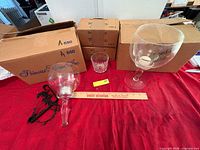 Overall lot showing two candle holders, one on stem and one with chain, plus whiskey glass and Princess House boxes