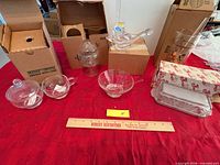 All items laid out including butter dish, covered bowls, open bowl, bird figurine, pitcher in boxes