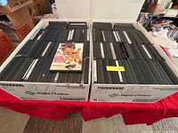 Two boxes filled with DVD cases, example title shown