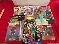 Full lot spread on red cloth showing all comics and magazines