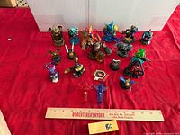 Group shot of all Skylanders figures with ruler for scale