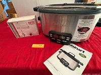 Cuisinart cooker, detachable control panel, booklet, and Waring hand mixer box on table