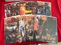 All ten bagged comics displayed fanned out on red cloth