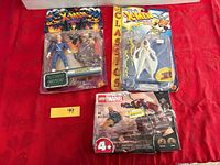 Front view of all three sealed items on red surface