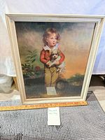 Full view of framed print with ruler and note for scale