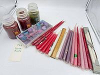 Overview of two jar candles, tealight box and numerous tapers