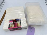 ArtMinds paraffin wax block package beside plastic tub of soy wax