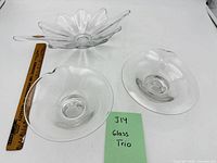 Group shot of starburst handled dish and two round bowls with ruler for scale