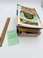 Stack of booklet lot beside ruler