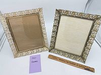 Two ornate gold-tone metal frames side by side with ruler for scale