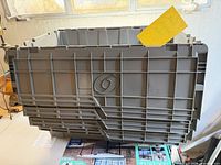 Front view of gray plastic tub showing logo and lid design